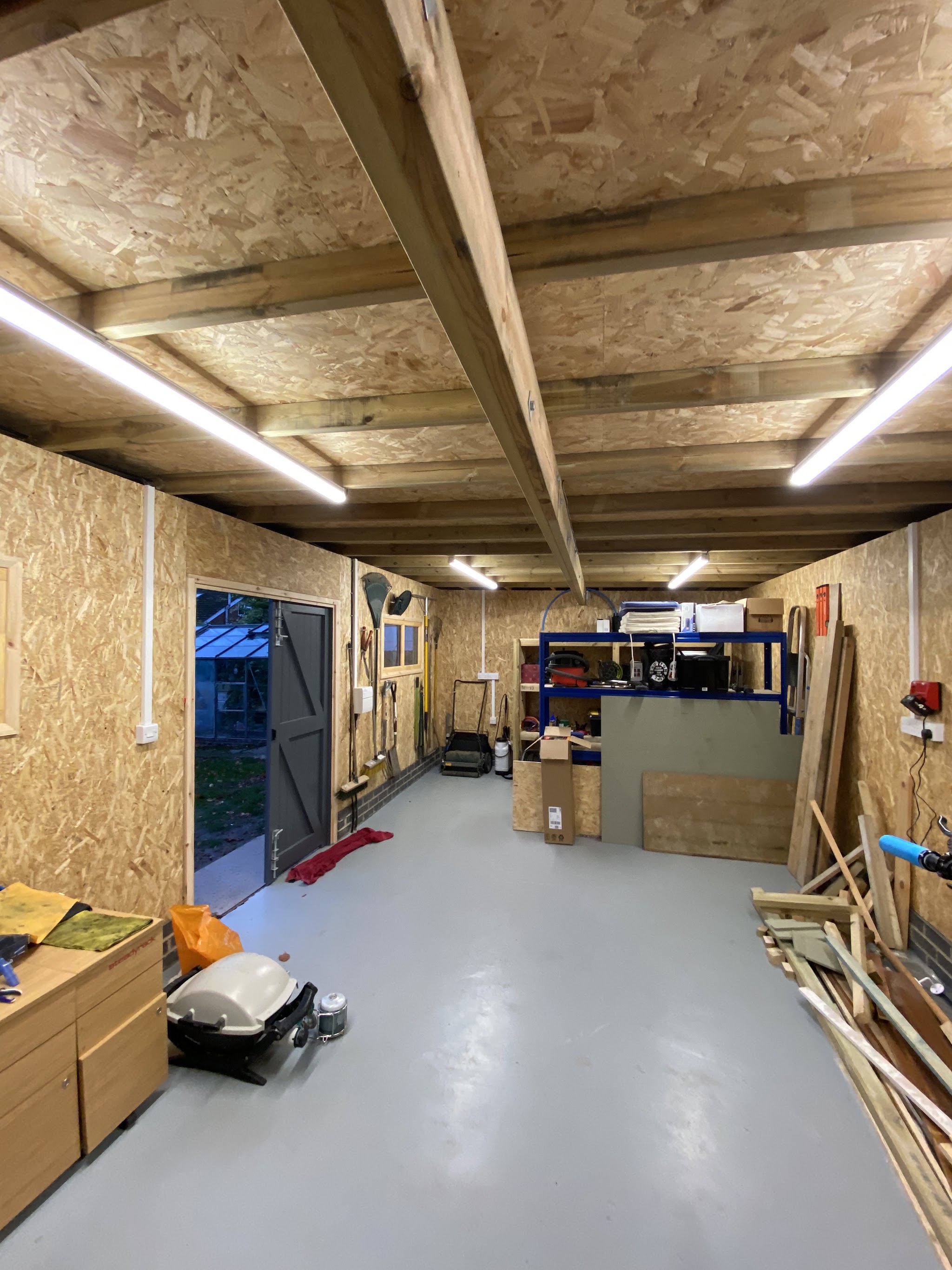 Workshop interior with LED batten lights along the ceiling and sockets on the walls
