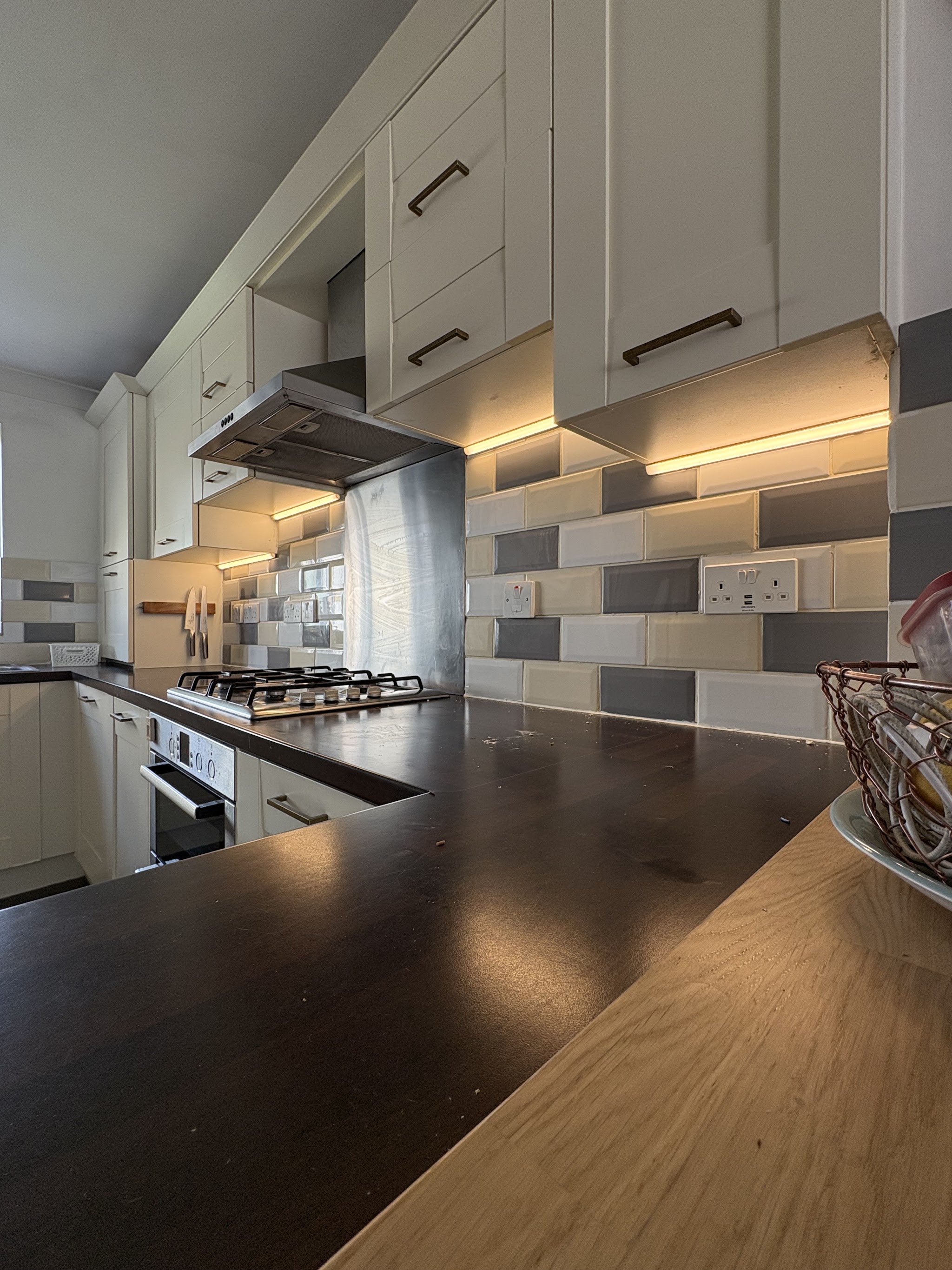 Kitchen with warm under-cabinet LED lighting along the worktops