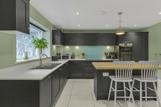 Kitchen in the Marcham extension with pendant lights over the island and ceiling downlights